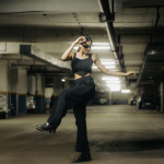 Person wearing black trip pants for everyday wear showcasing alternative streetwear style