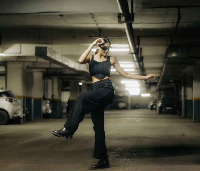 Person wearing black trip pants for everyday wear showcasing alternative streetwear style
